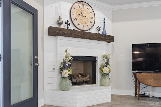 living room featuring crown molding, a fireplace, and hardwood / wood-style floors