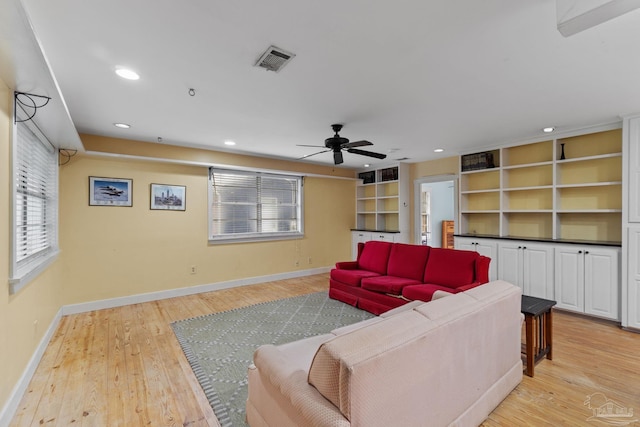 living area featuring light wood-style flooring, visible vents, and a healthy amount of sunlight