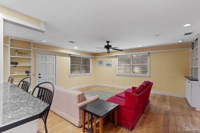 living room featuring light wood finished floors, recessed lighting, visible vents, and baseboards