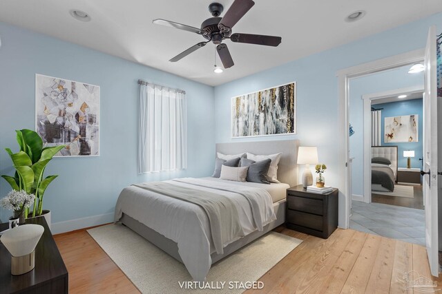 bedroom with light wood-type flooring, baseboards, a ceiling fan, and recessed lighting