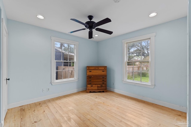 empty room featuring a ceiling fan, recessed lighting, hardwood / wood-style flooring, and baseboards