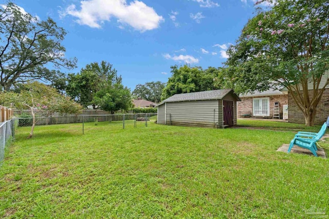 view of yard featuring an outbuilding, a shed, and a fenced backyard