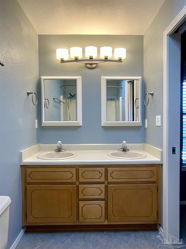 bathroom featuring a sink, toilet, and double vanity