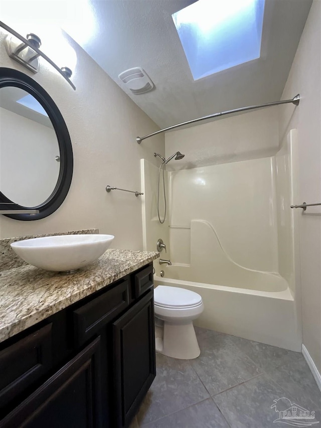 bathroom with visible vents, toilet, vanity, shower / tub combination, and tile patterned flooring