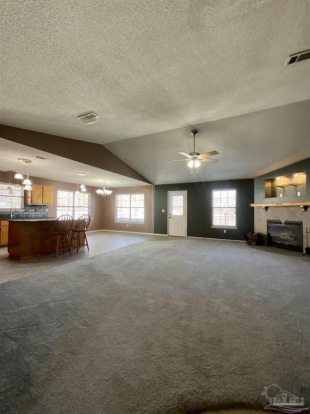 unfurnished living room featuring light carpet, plenty of natural light, and visible vents