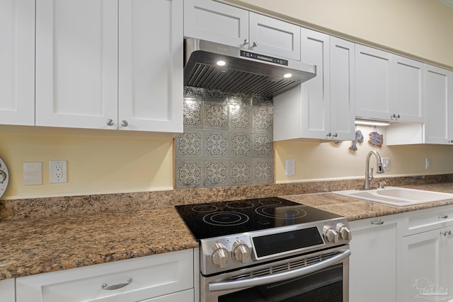 kitchen featuring white cabinetry, extractor fan, stainless steel electric range oven, and a sink