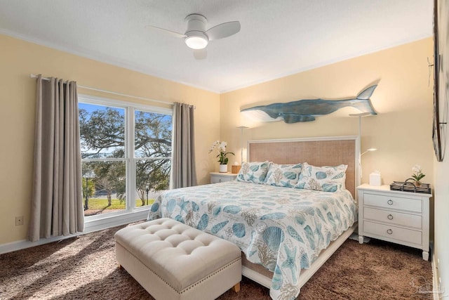 carpeted bedroom with ceiling fan and ornamental molding