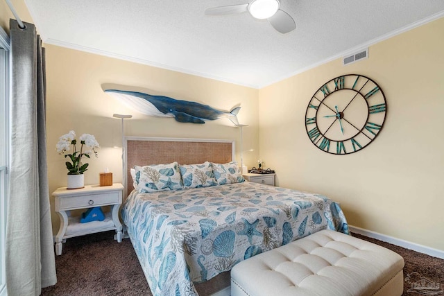 bedroom with visible vents, carpet floors, a textured ceiling, and crown molding