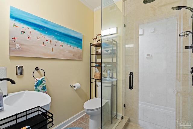 bathroom with toilet, a stall shower, ornamental molding, a sink, and baseboards