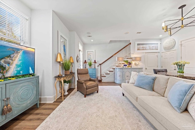 217 W Jackson St Unit 12, Pensacola, FL 32501 - living room with recessed lighting, wood finished floors, stairs, a notable chandelier, and baseboards