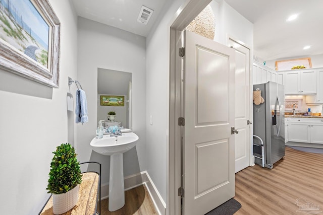 217 W Jackson St Unit 12, Pensacola, FL 32501 - bathroom featuring visible vents, baseboards, and wood finished floors