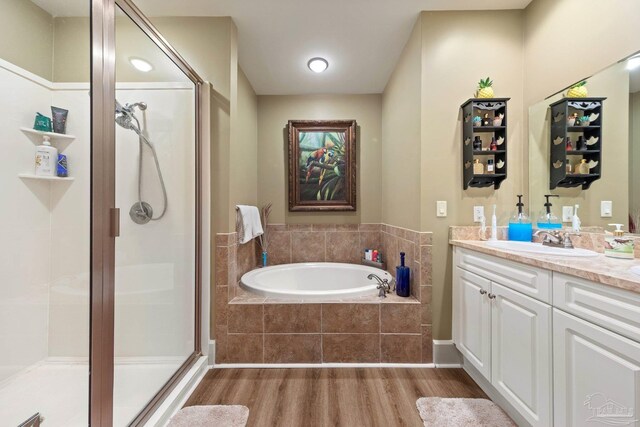 217 W Jackson St Unit 12, Pensacola, FL 32501 - bathroom with a bath, a shower stall, vanity, and wood finished floors