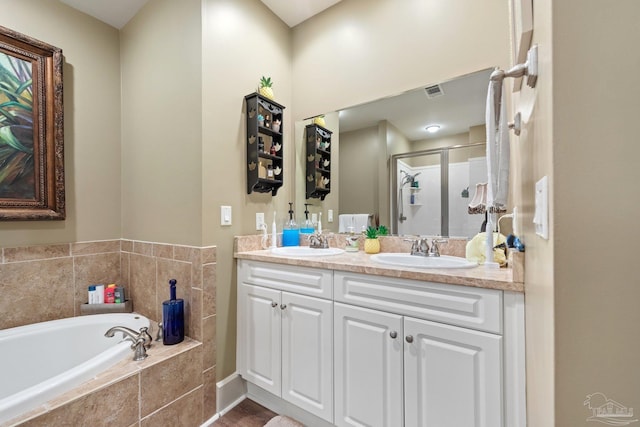 217 W Jackson St Unit 12, Pensacola, FL 32501 - bathroom featuring a bath, a stall shower, double vanity, and a sink