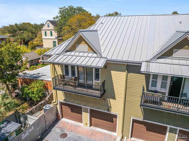 217 W Jackson St Unit 12, Pensacola, FL 32501 - view of front facade featuring a standing seam roof, metal roof, fence, and an attached garage