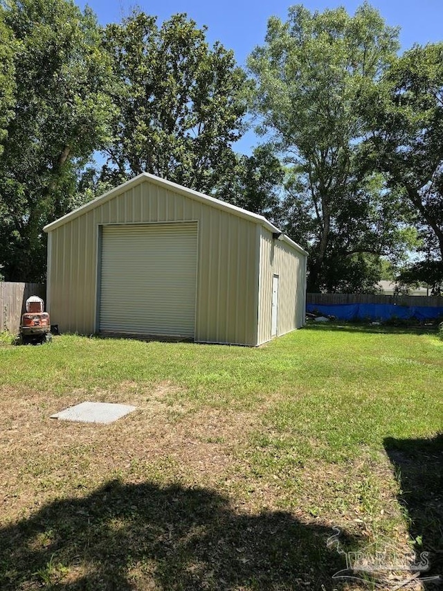 view of outdoor structure featuring a garage and a yard