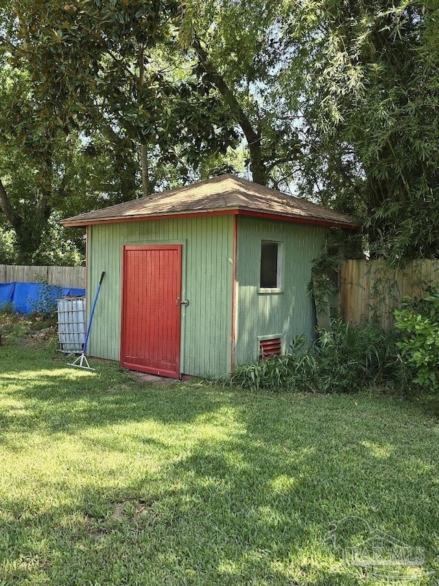 view of outbuilding with a lawn