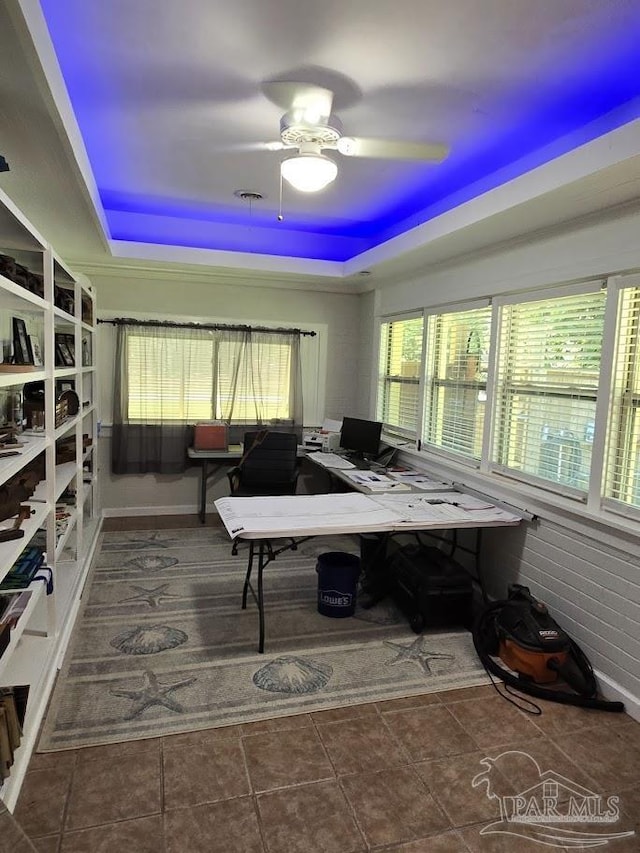 office featuring ceiling fan and a tray ceiling