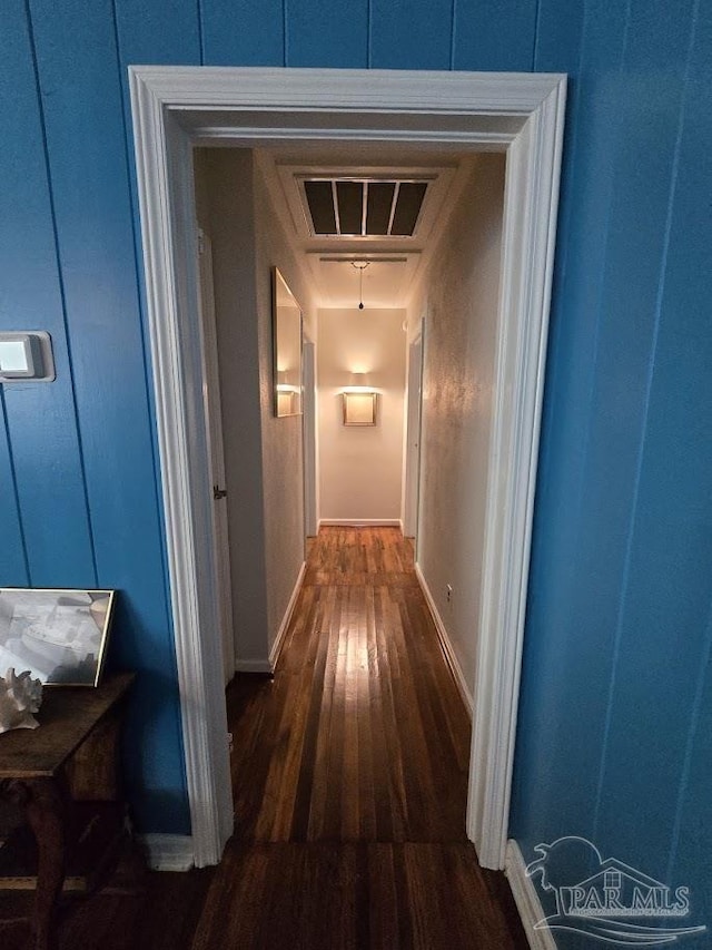 hallway with dark hardwood / wood-style floors