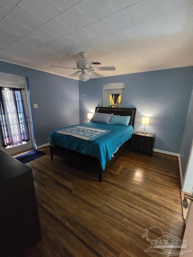 bedroom with ceiling fan, dark hardwood / wood-style flooring, and access to exterior