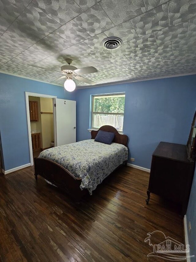 bedroom with dark hardwood / wood-style flooring and ceiling fan