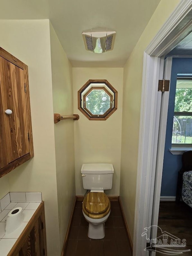 bathroom featuring tile patterned flooring, vanity, and toilet