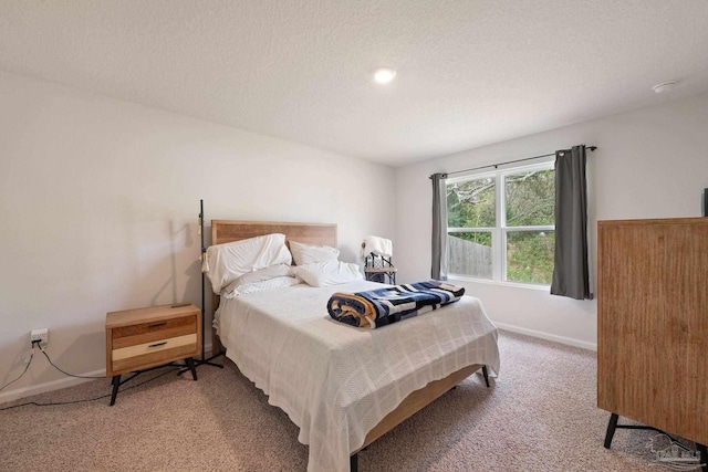 carpeted bedroom featuring a textured ceiling