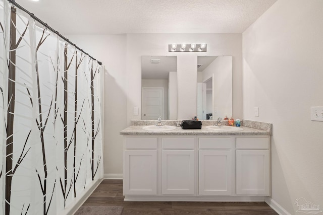 bathroom with hardwood / wood-style floors, vanity, a textured ceiling, and a shower with shower curtain