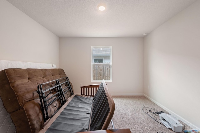 bedroom featuring carpet flooring and a textured ceiling