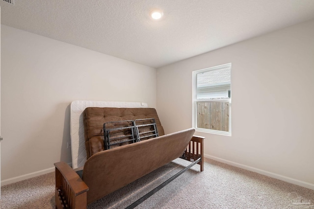 carpeted bedroom featuring a textured ceiling