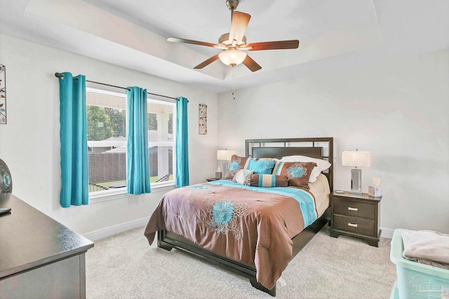 bedroom with light carpet, baseboards, and a ceiling fan