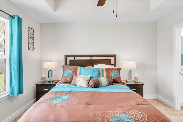 bedroom featuring baseboards, multiple windows, and a ceiling fan