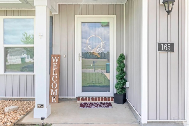 property entrance featuring board and batten siding