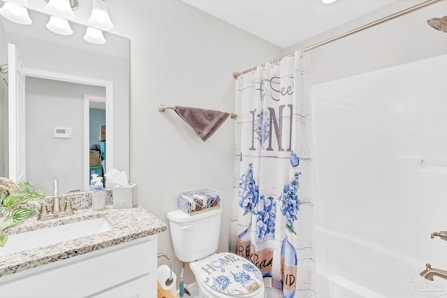 bathroom featuring shower / tub combo, vanity, and toilet