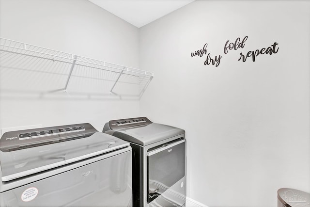 laundry area featuring separate washer and dryer and baseboards