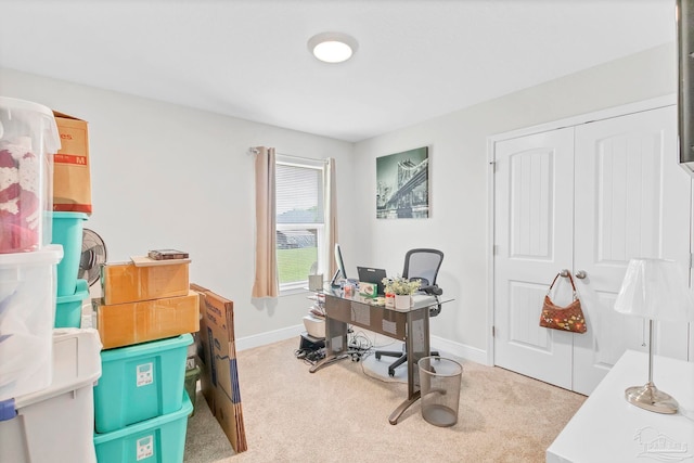 office area featuring light colored carpet and baseboards