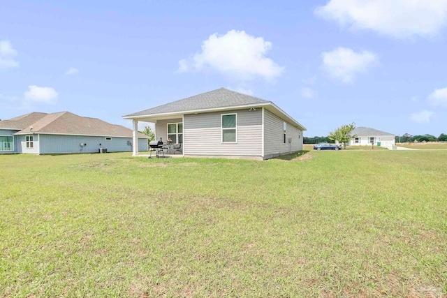 back of house with a yard and a patio area