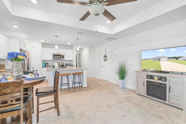 dining space featuring light carpet, ceiling fan, recessed lighting, and baseboards