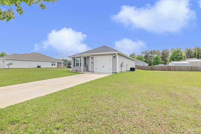 ranch-style home with driveway, central AC, and a garage