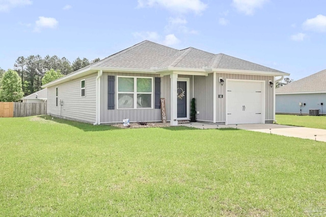 view of front of home with a garage, driveway, central AC, and a shingled roof