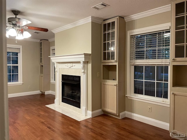 3036 Laurel Dr, Gulf Breeze, FL 32563 - unfurnished living room featuring a ceiling fan, dark wood-type flooring, a tile fireplace, baseboards, and ornamental molding