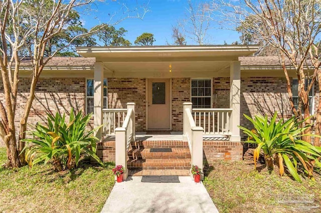 3036 Laurel Dr, Gulf Breeze, FL 32563 - view of front facade with brick siding and a porch