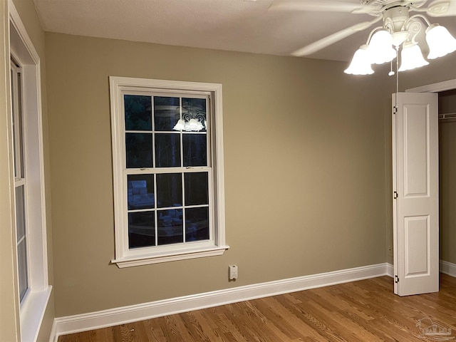 3036 Laurel Dr, Gulf Breeze, FL 32563 - empty room featuring wood finished floors, baseboards, and a ceiling fan