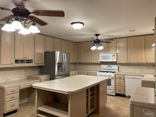 3036 Laurel Dr, Gulf Breeze, FL 32563 - kitchen featuring white appliances, ceiling fan, open shelves, tile countertops, and light tile patterned floors