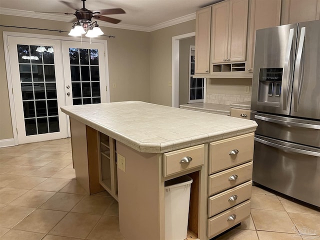 3036 Laurel Dr, Gulf Breeze, FL 32563 - kitchen with stainless steel fridge with ice dispenser, ceiling fan, tile countertops, light tile patterned floors, and ornamental molding