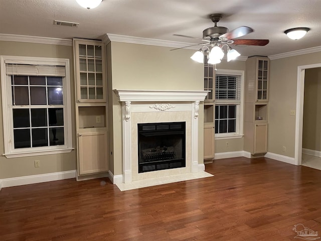 3036 Laurel Dr, Gulf Breeze, FL 32563 - unfurnished living room featuring ceiling fan, wood finished floors, a tile fireplace, ornamental molding, and baseboards