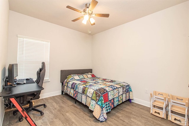 bedroom featuring hardwood / wood-style floors and ceiling fan