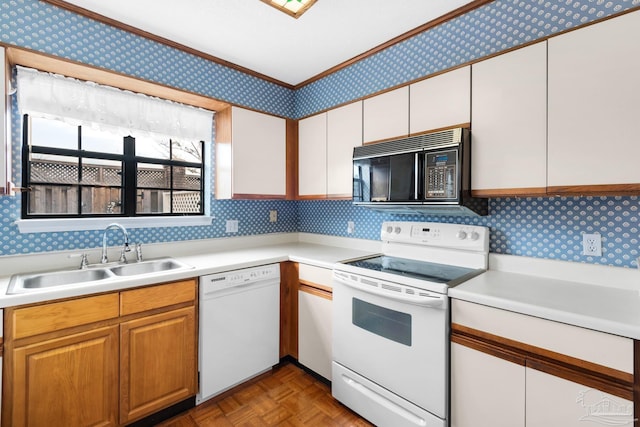 kitchen with sink, backsplash, light parquet floors, white appliances, and white cabinets