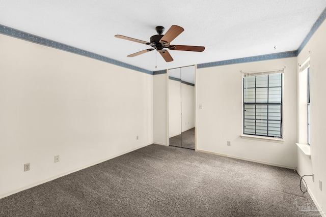 unfurnished bedroom featuring ceiling fan, a closet, and carpet floors