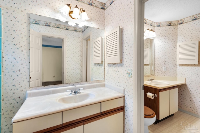 bathroom featuring a textured ceiling and vanity