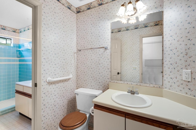 bathroom with vanity, toilet, an inviting chandelier, and walk in shower